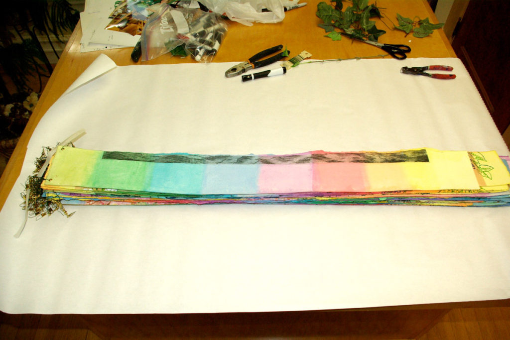 Transporting "Circle of Life." Wrapping the number-ordered, rainbow strips.